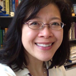 Lady with Black hair and glasses. Dr. Kawai Tam